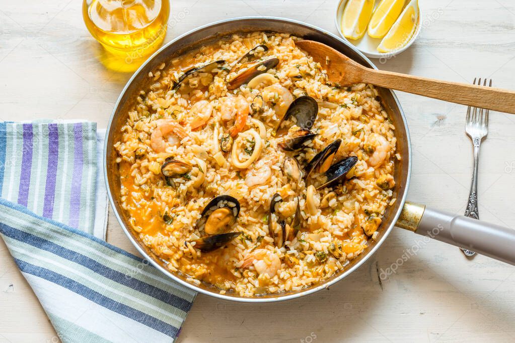 Seafood risotto in a frying pan - a classic Italian dish