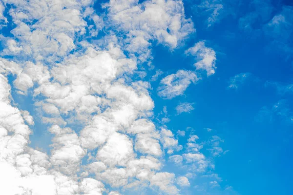 Beautiful blue sky and white light clouds illuminated by the sun