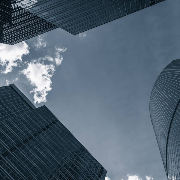 Modern buildings in city against blue sky
