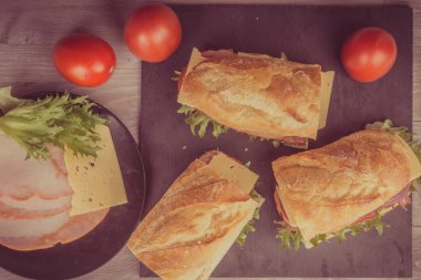 Jambonlu, peynirli, marullu, soğanlı ve domatesli taze sandviç.