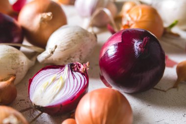 Eski bir ahşap masanın üzerinde yatan farklı soğan ampuller birkaç tür beyaz boyalı.