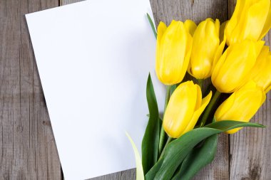 Buket Sarı laleler ve hediye kutusu gri ahşap zemin üzerine