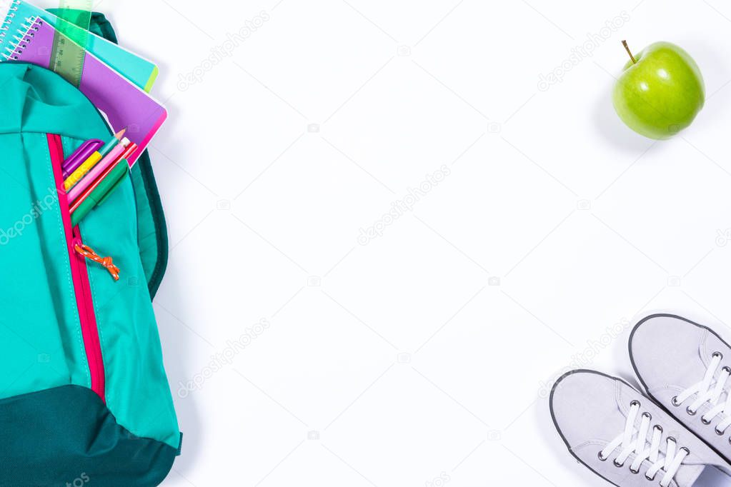 Backpack with school stationery on white background