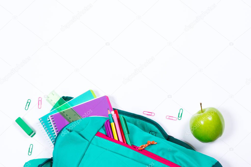 Backpack with school stationery on white background