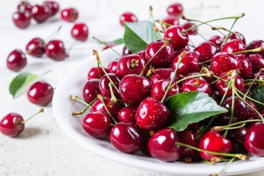 Beyaz plaka üzerinde taze kırmızı Olgun Kiraz