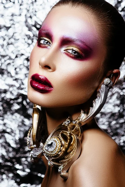 Brunette woman in long earrings. high school model with creative make-up — Stock Photo, Image