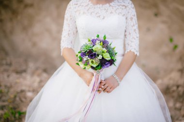 bir buket tutan gelin. düğün çiçekleri. yumuşak odak.