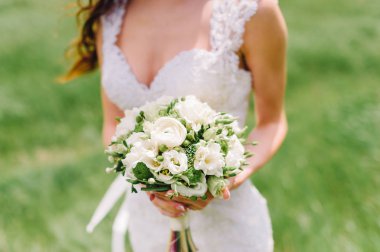 bir buket tutan gelin. düğün çiçekleri. yumuşak odak.