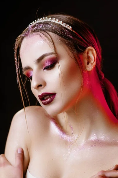 portrait of a girl with a gold crown. Model with creative make-up.