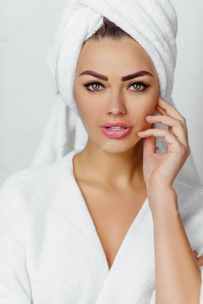 Beautiful young woman in towel all ready to get spa treatment. girl is sexually posing