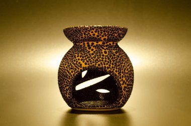 Aroma terapi lambası altın bir arka plana karşı