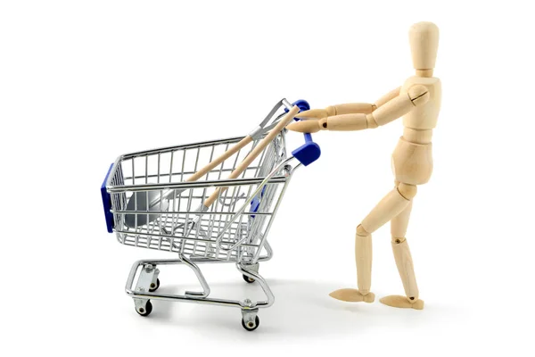 Wooden mannequin shopping garden tools with a cart on white isol — Stock Photo, Image