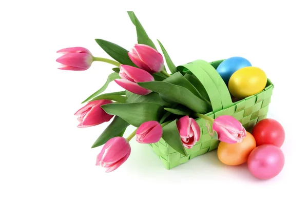 Easter eggs with a basket and bunch of pink tulips on isolated w — Stock Photo, Image