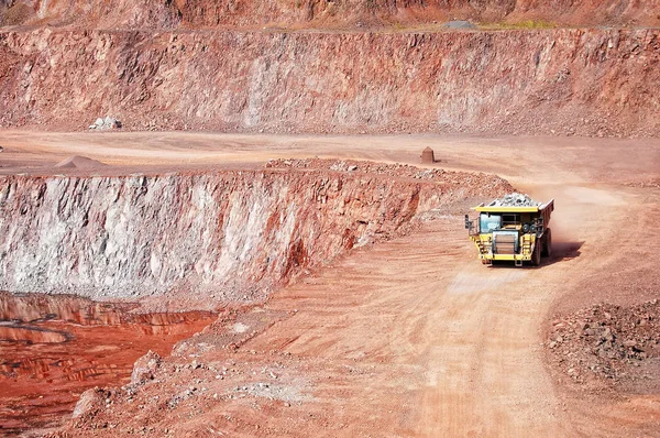 Quarry mine of porphyry rock. dumper truck driving around — Stock Photo, Image