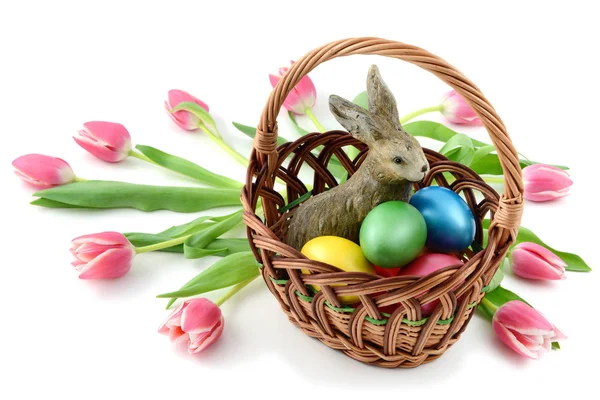 Easter rabbit in a basklet with easter eggs and tulips on white — Stock Photo, Image