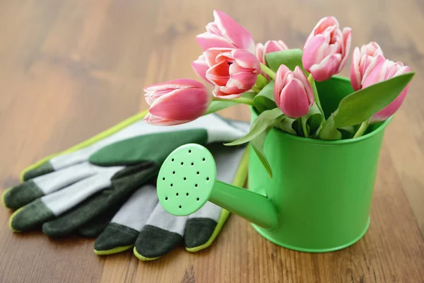 Green waten can with bunch of tulips — Stock Photo, Image