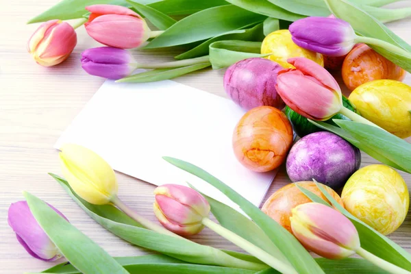 Easter eggs and tulips with copy space — Stock Photo, Image