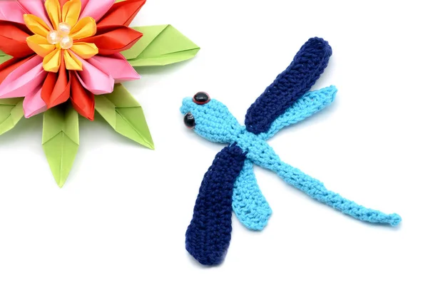 Tinker with wool and paper a crochet dragon fly and paper water — Stock Photo, Image