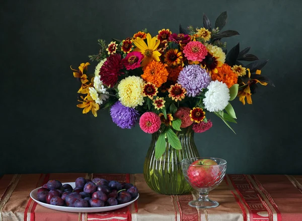 Natura morta con bouquet e prugne . — Foto Stock