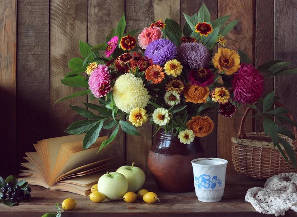 Still life with bouquet, apples, plums and an open book. — Stock Photo, Image