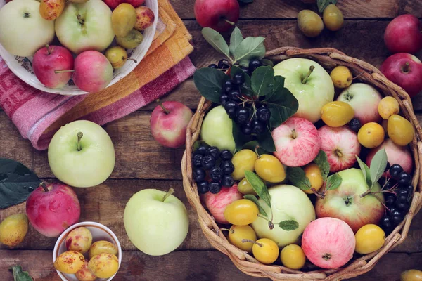 Jablka a švestky na stole, pohled shora. Tabulka-zátiší. — Stock fotografie
