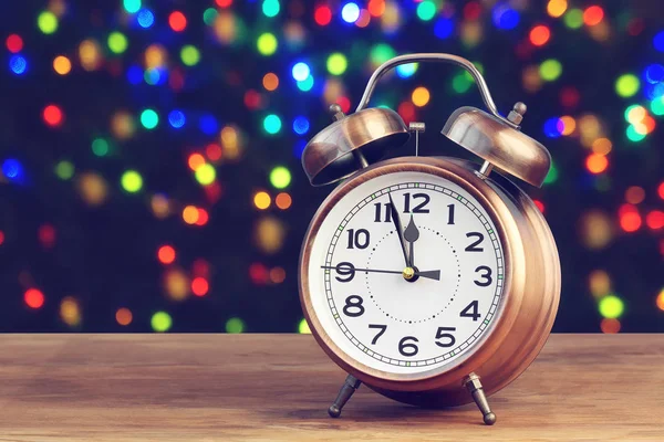 Alarm clock at twelve o\'clock. Minutes about New year.