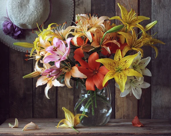 Bouquet of colorful lilies in a jar — Stock Photo, Image