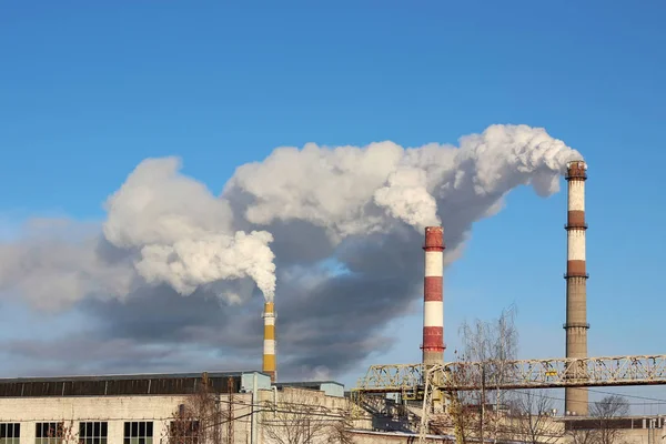 Dense smoke burst from the three factory chimneys. — Stock Photo, Image