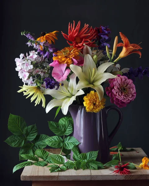 Bouquet of garden flowers in a jug. Still life. — Stock Photo, Image