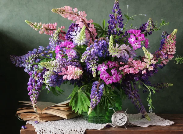 Still life with flowers in a vase. Bouquet of lupine. — Stock Photo, Image