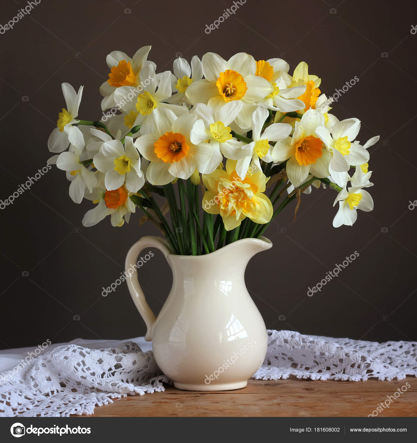 Bouquet of garden daffodils in a white jug. narcissus. Stock Photo by  ©BalaguR 181608002