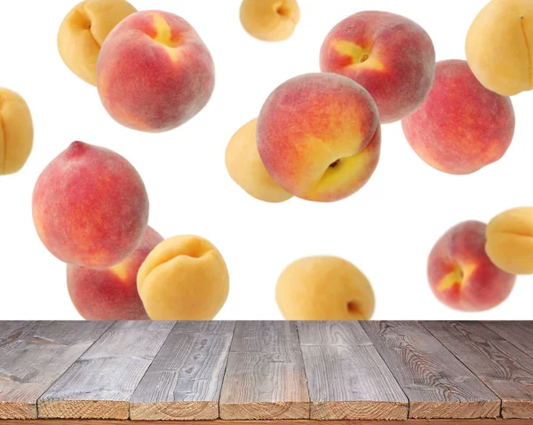 Empty  table top on background of flying peaches and apricot.