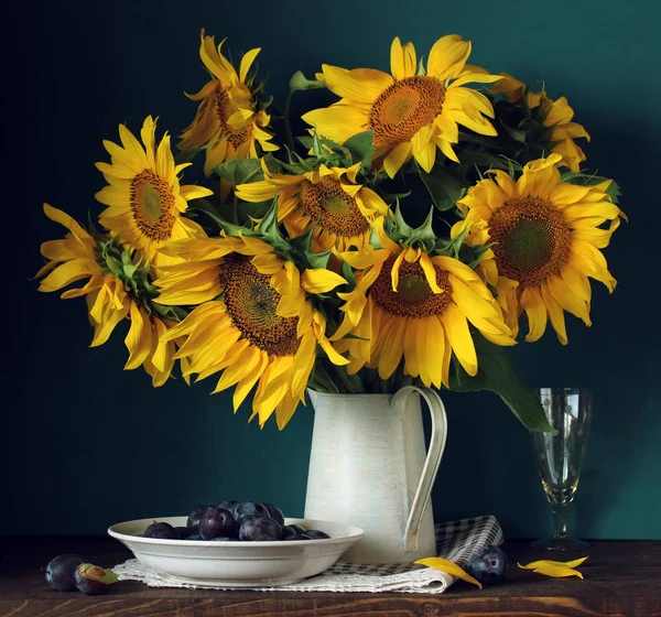 Sunflowers and plums. bouquet of garden flowers and berries — Stock Photo, Image