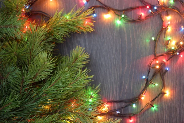 Composición navideña con ramas de pino y guirnalda eléctrica, t — Foto de Stock