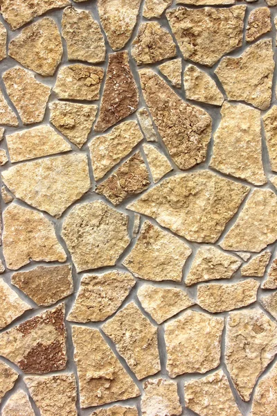 Wall is covered with natural yellow stone. texture, exterior. — Stock Photo, Image