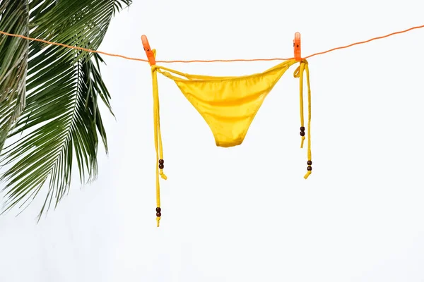 Bikini hanging on white Stock Photo