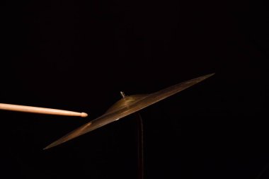 Müzisyen davul palet siyah arka plan üzerine vuruyor