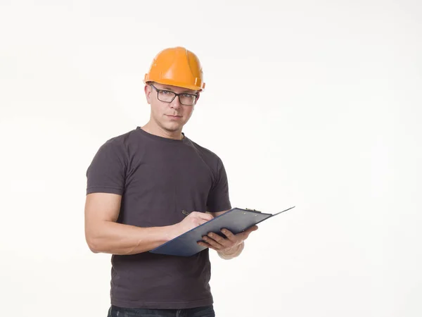 Joven Trabajador Casco Con Una Carpeta Imagen de stock