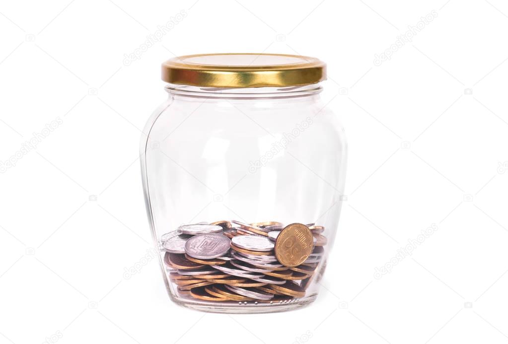 Coins in glass jar isolated on white background