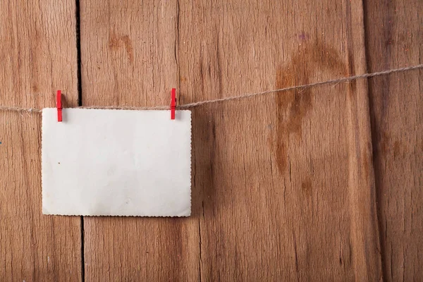 Old paper on rope on wood background. — Stock Photo, Image