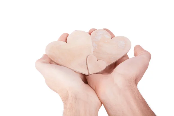 Mão segurando coração de madeira — Fotografia de Stock