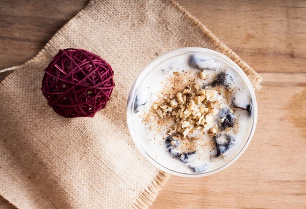 Desserts with prune, walnut and sour cream in vase. — Stock Photo, Image