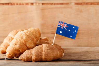 Taze kruvasan ve ahşap masa üzerine Avustralya bayrağı