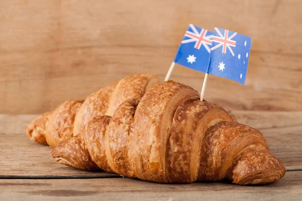 Fresh croissant and australian flag on wood desk