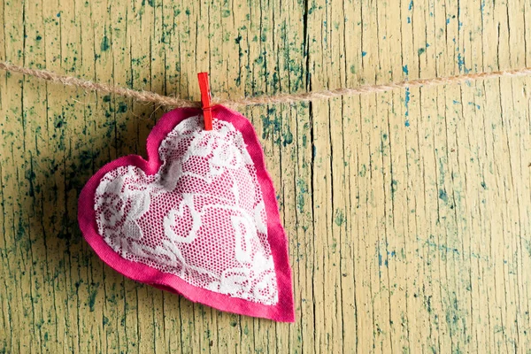 Heart made of cloth on wood desk — Stock Photo, Image