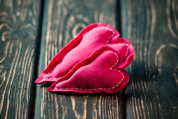 Heart made of cloth on wood desk — Stock Photo, Image