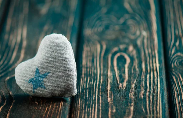 Heart made of cloth on wood desk — Stock Photo, Image