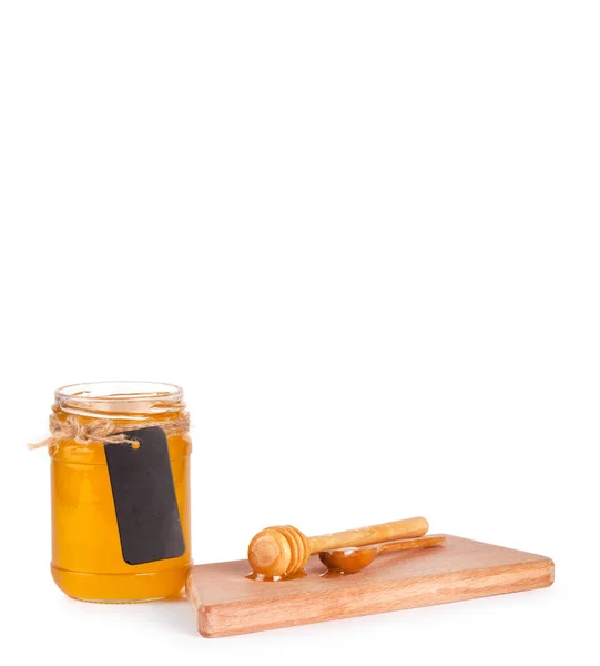 Jar of honey and honey dipper — Stock Photo, Image