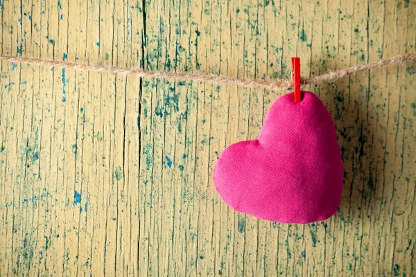 Heart made of cloth on wood desk. — Stock Photo, Image