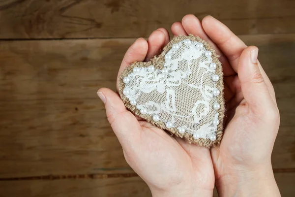 Heart from cloth on wood desk